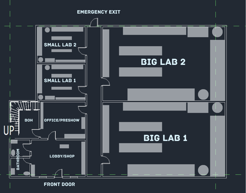 Floor-plan blueprint of the ground floor: shop, office, labs, bathrooms, and stairs